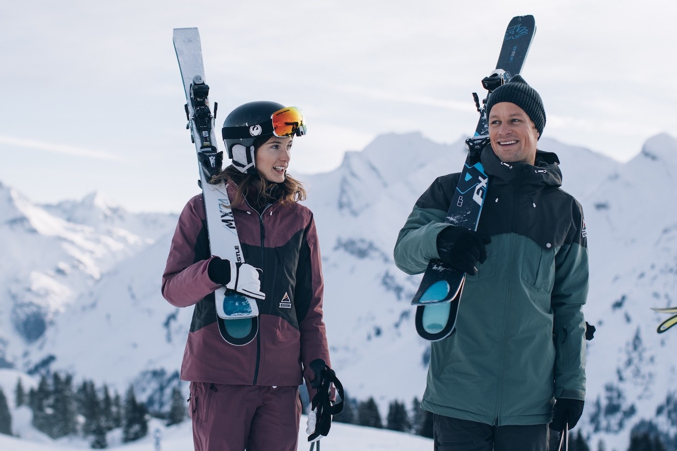 Couple skiing in St. Anton Alps, skiing at different skill levels during ski holiday in Austria
